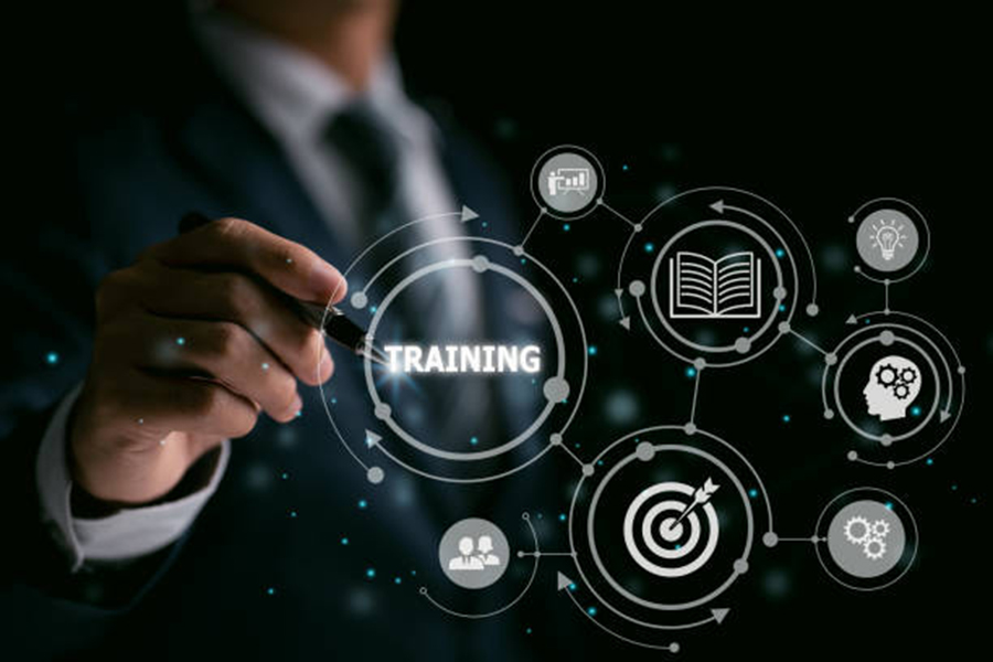 man in suit holding a pen pointing at digital sign that says training